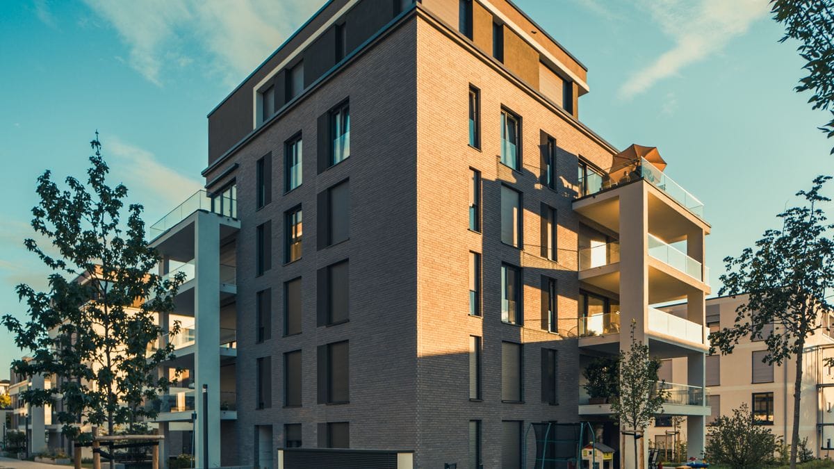 Residential apartment building with landscaped lawn